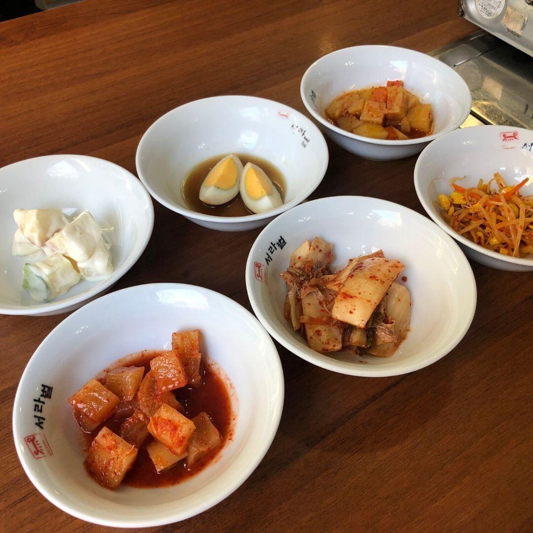 Seorabeol'da banchan garnitürleri ve fermente kimchi tabağı