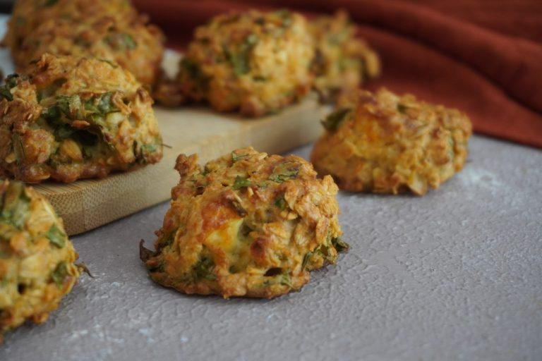 Altın rengi kabuklu, yulaf taneleriyle bezeli, içi pofuduk ve yumuşacık kıvamda, taze fesleğen ve dereotunun yeşil dokunuşlarıyla doğal malzemelerin zenginliğini sunan poğaçalar.