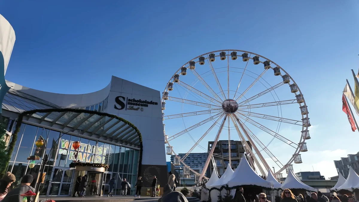 Entrance of the Chocolate Museum (Schokoladenmuseum) in Cologne with a Ferris wheel beside it