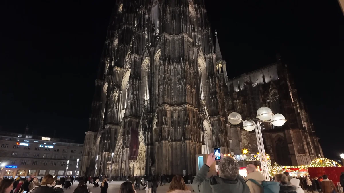 Cologne Cathedral lit up at night next to the central station area