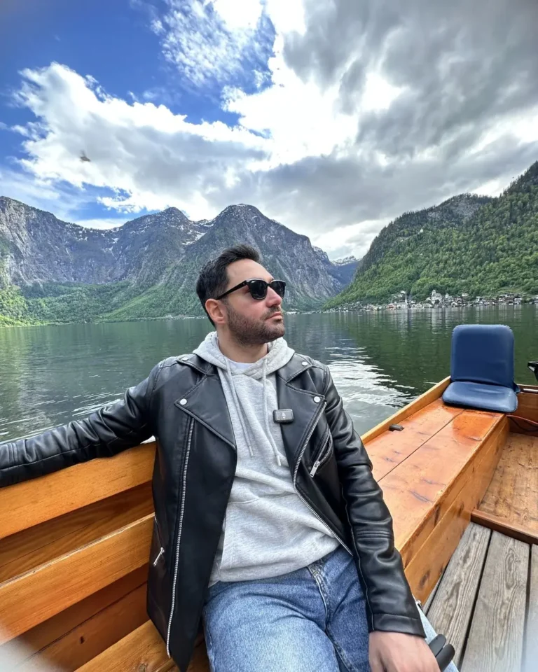 Hallstatt Gölü'nde geleneksel ahşap tekne turunda Gezginbirchef, arka planda Alp dağları ve kasabanın çatıları