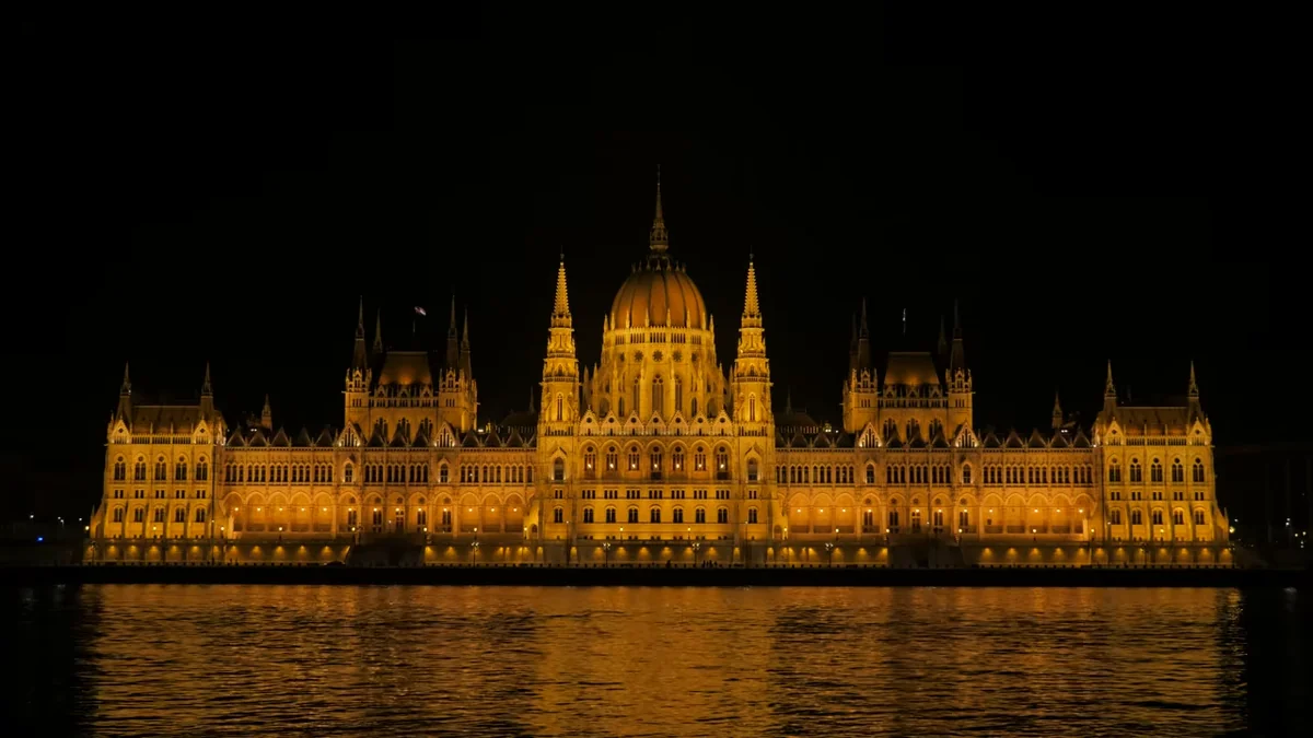 Budapeşte Parlamento Binası gece Tuna Nehri’nden aydınlatılmış hâliyle