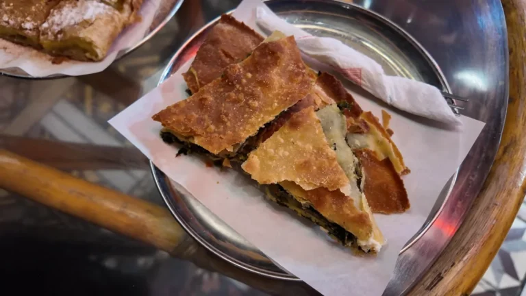 A crisp filo bougatsa slice on a metal tray at Bougatsadiko Psirri, Athens