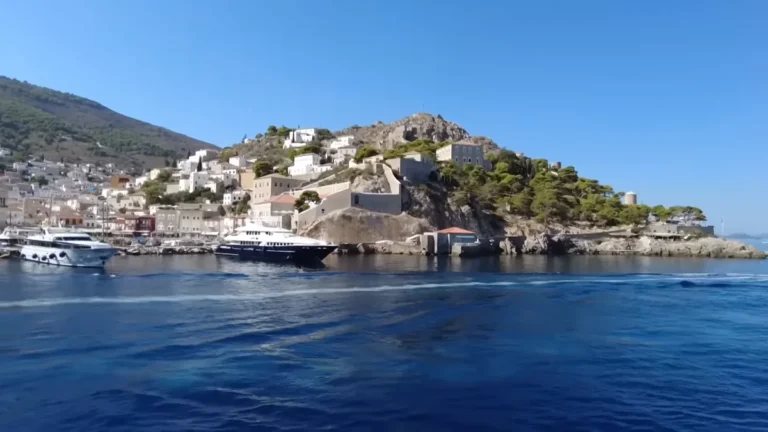 Hydra harbour and hillside stone houses seen from the approaching boat