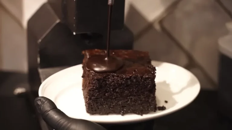 Chocolate sauce poured over zoumero cake at Koukouvaya, Athens