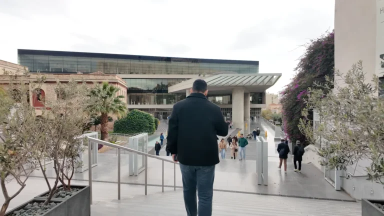 The pedestrian walkway and visitors in front of the Acropolis Museum in Makrygianni