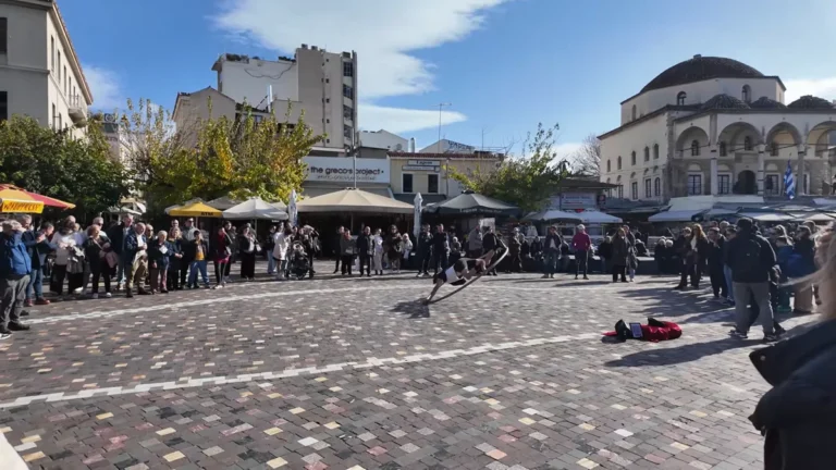 Crowds on Monastiraki Square with Tzistarakis Mosque and the Acropolis behind