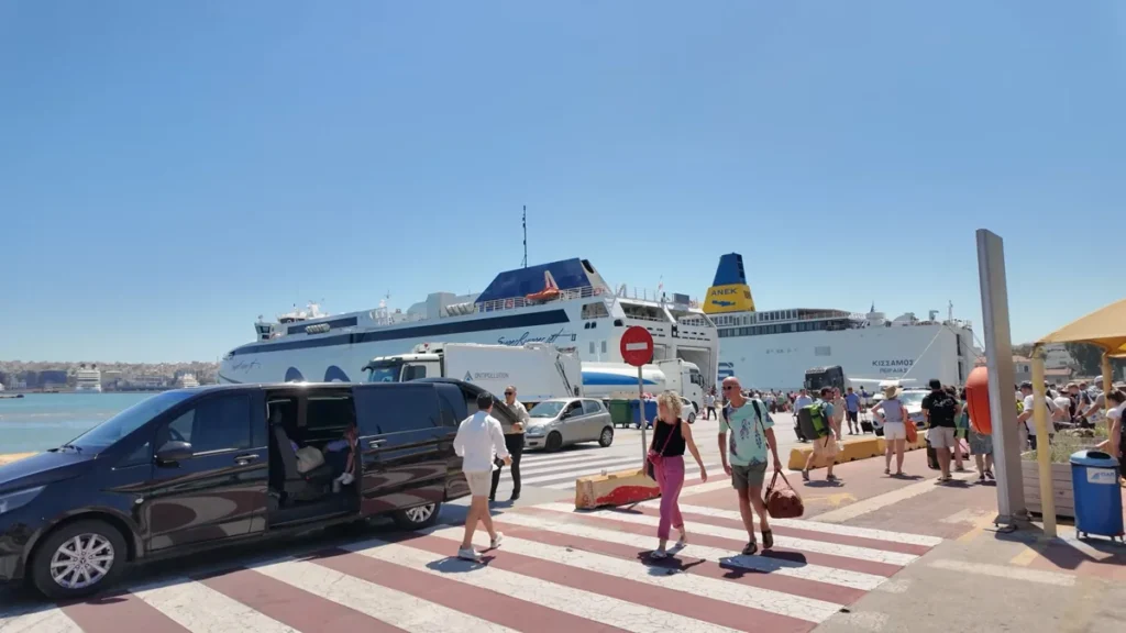 Pire Limanı rıhtımında yanaşmış büyük feribotlar ve yolcular
