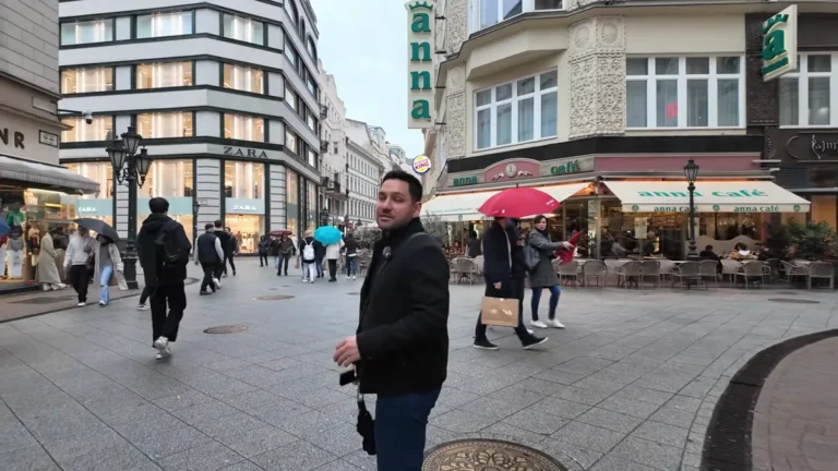 Budapeşte Váci Caddesi'nde yürüyen insanlar ve mağazalar
