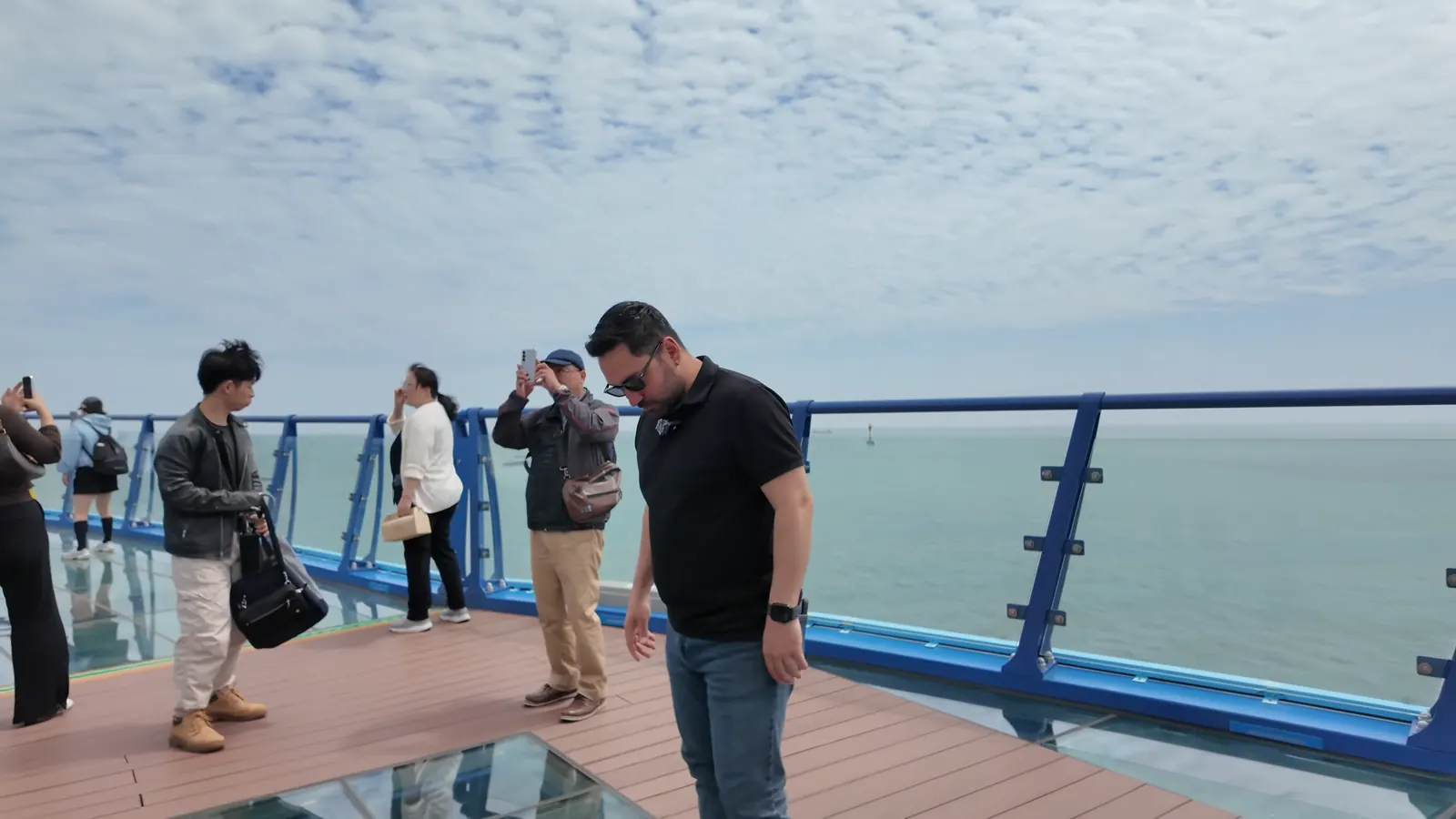 Cheongsapo Daritdol Skywalk’ta deniz üstündeki cam zeminde yürüyen ziyaretçiler, Busan