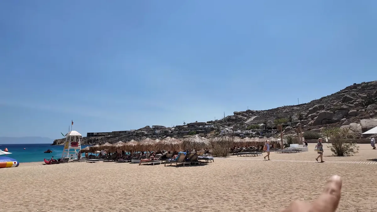 Umbrellas and sand at Super Paradise beach, Mykonos