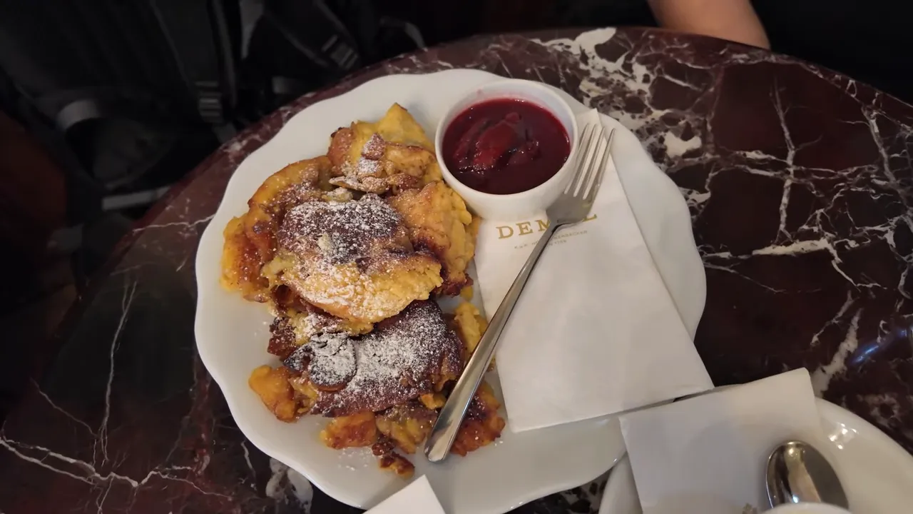 Kaiserschmarrn dusted with icing sugar and served with plum compote at Demel