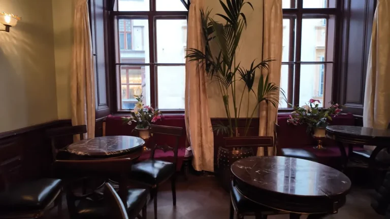 Red armchairs and marble tables in Demel's café salon