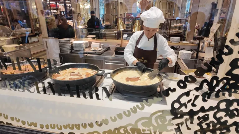 Cook making Kaiserschmarrn in a pan in Demel's street window