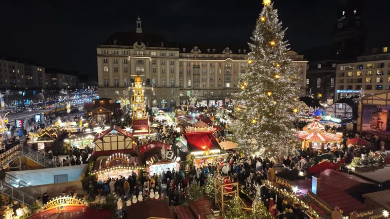 Dresden Striezelmarkt: the lit Christmas tree and wooden stalls on Altmarkt square