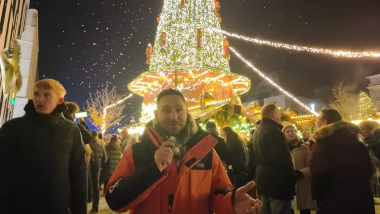Artificial snow falling over the lit tree at the Königsallee Christmas market in Düsseldorf