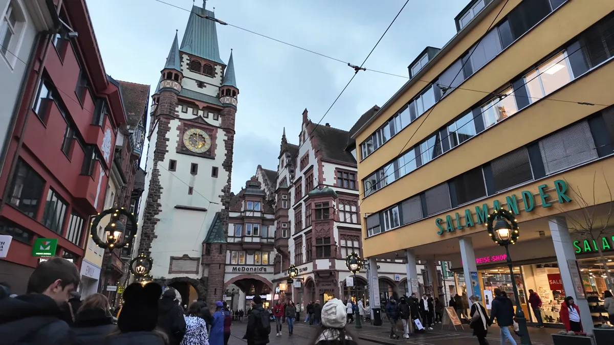 Martinstor clock tower gate above a shopping street in Freiburg
