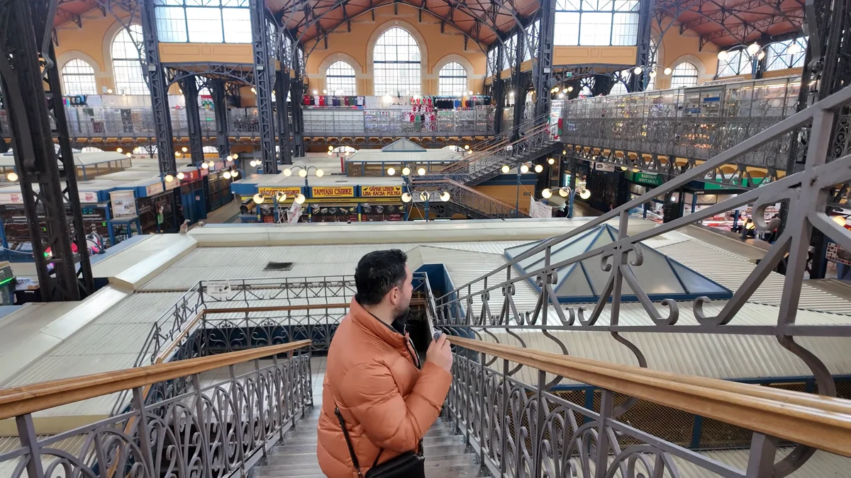 Halil on the upper gallery of the Great Market Hall in Budapest, with the main hall behind
