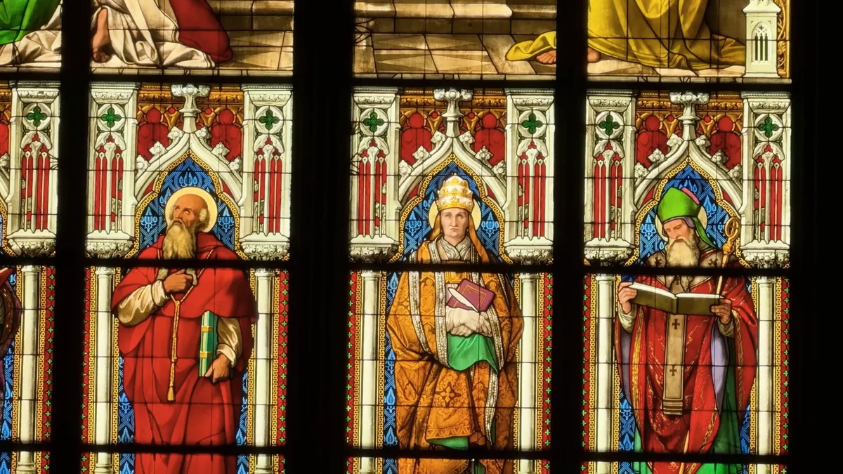 Saints in red and green robes in the colourful stained glass windows of Cologne Cathedral