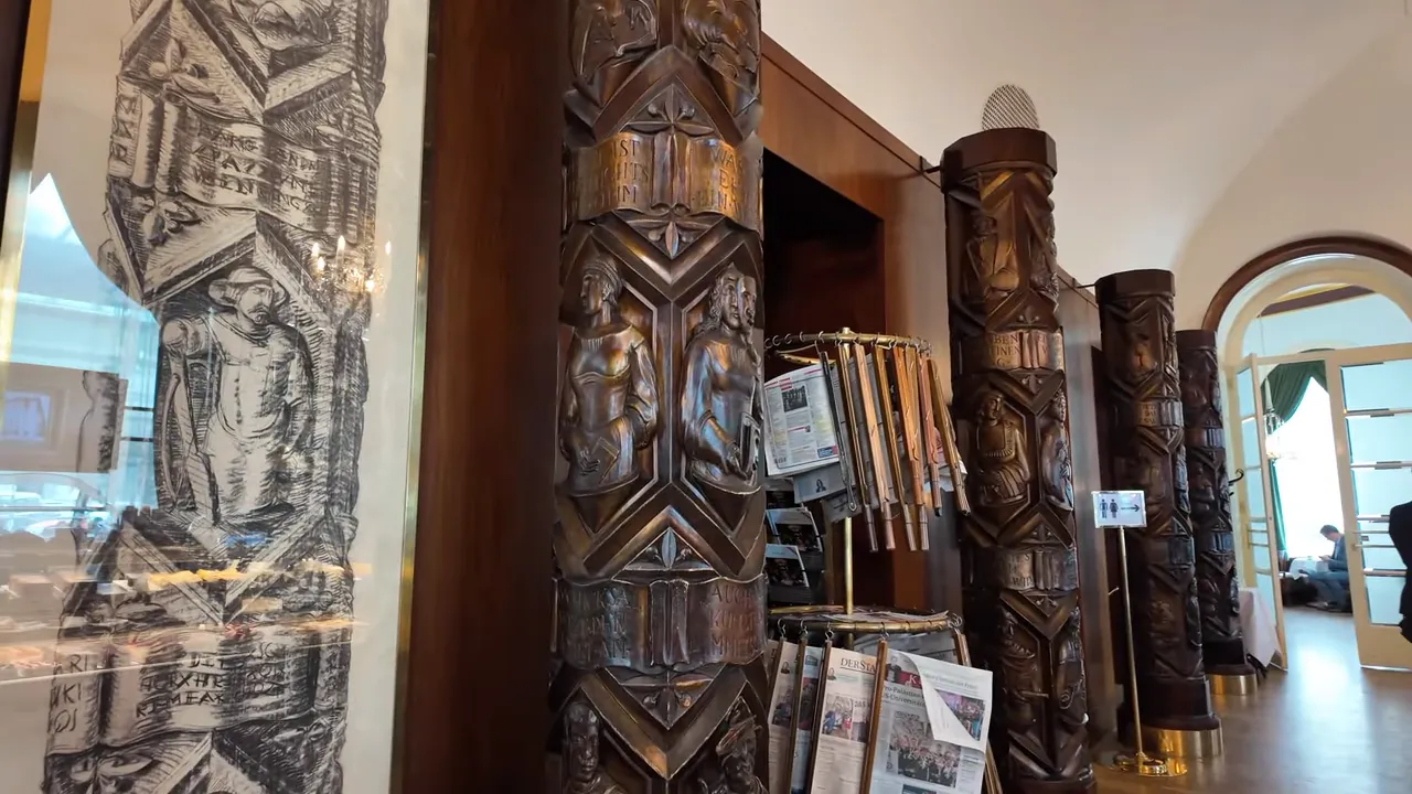 Carved wooden columns and newspaper racks at Café Landtmann
