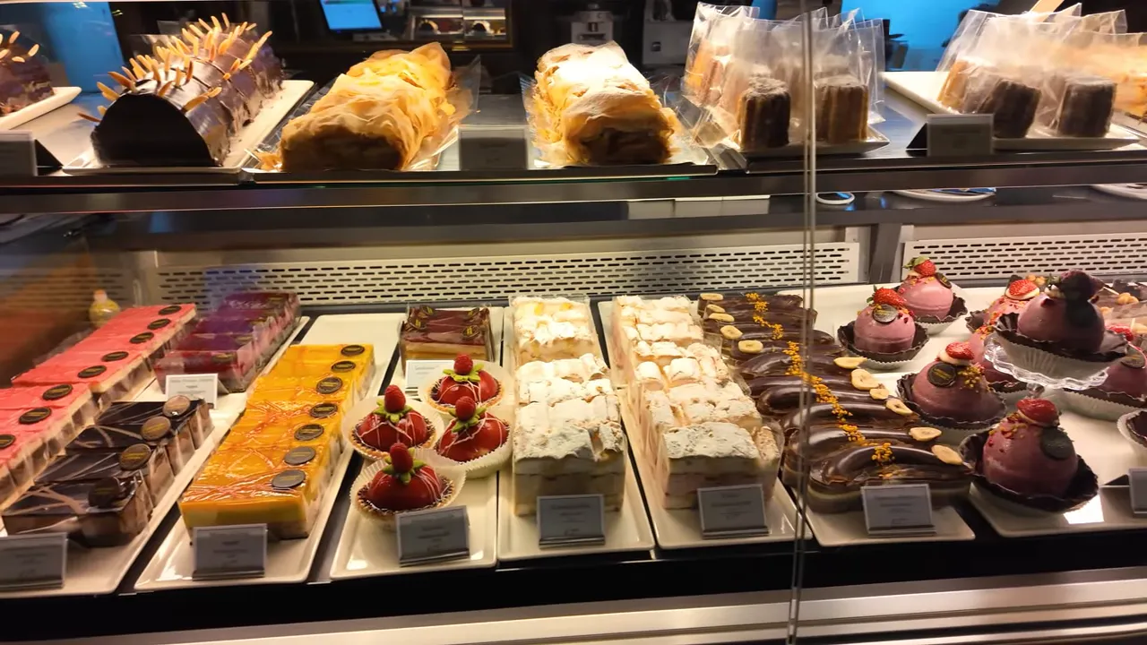 Cake display with slices of cake and tarts at Café Landtmann
