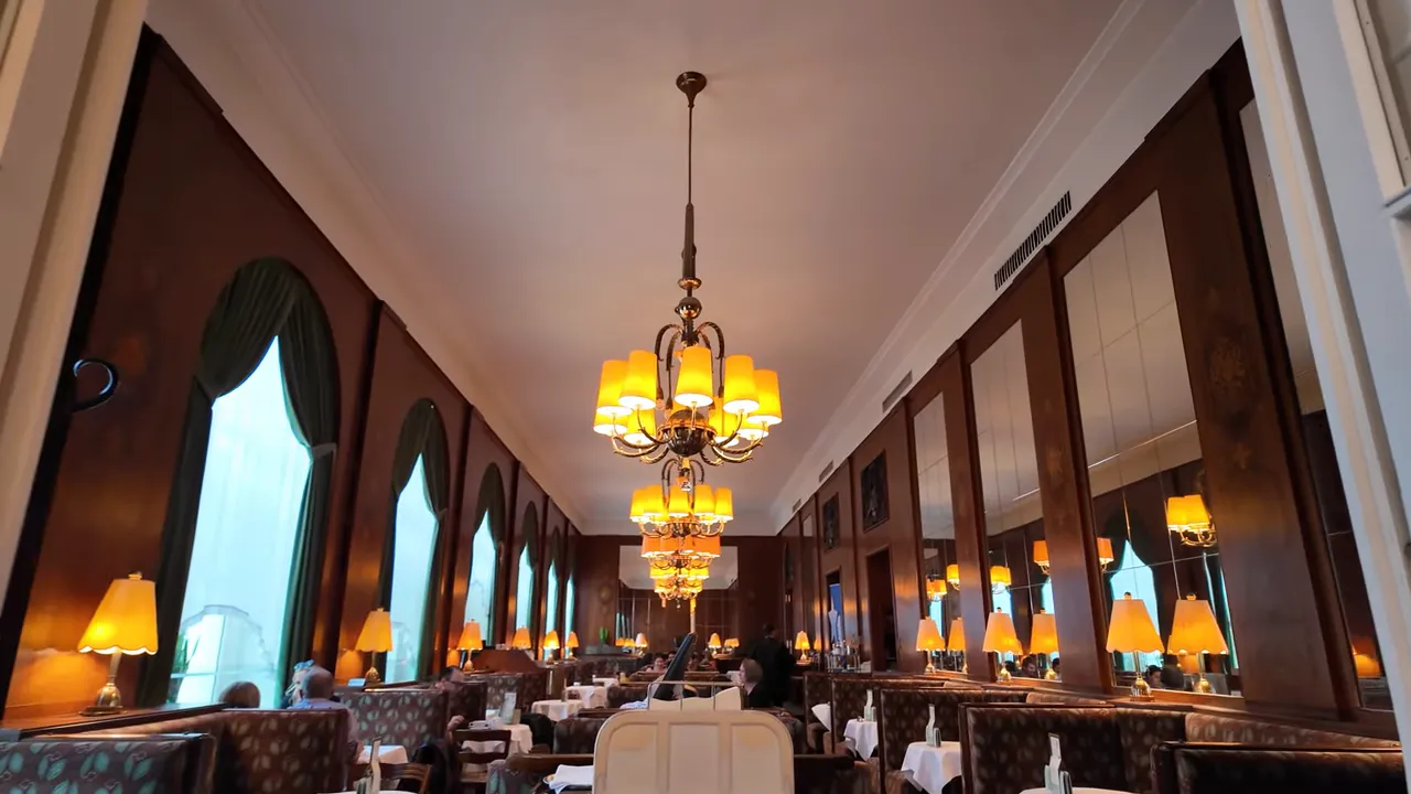 Long salon with chandeliers and window tables at Café Landtmann