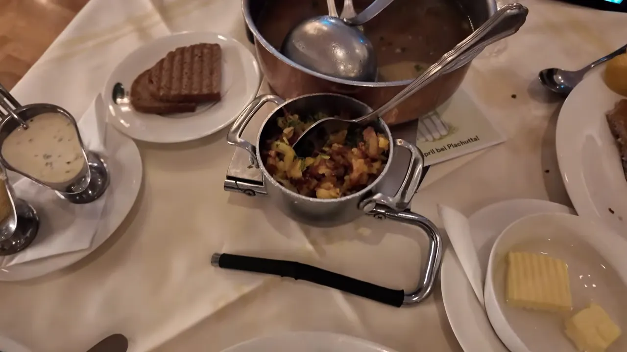 Tafelspitz served in a copper pot at Plachutta with rösti and rye bread