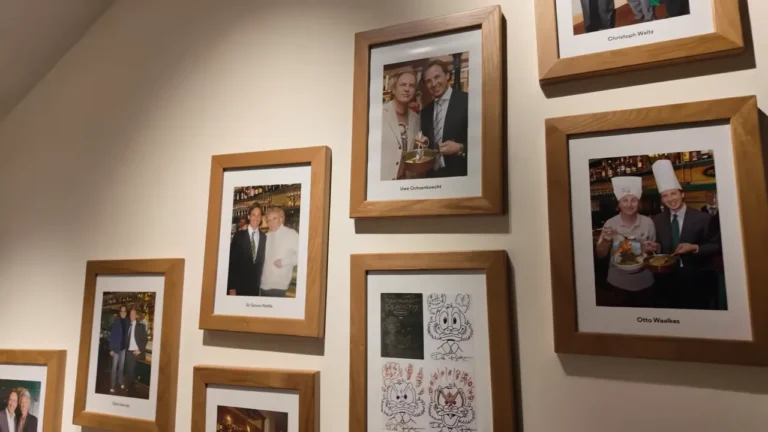 Wall of framed photos of famous guests inside Plachutta Wollzeile