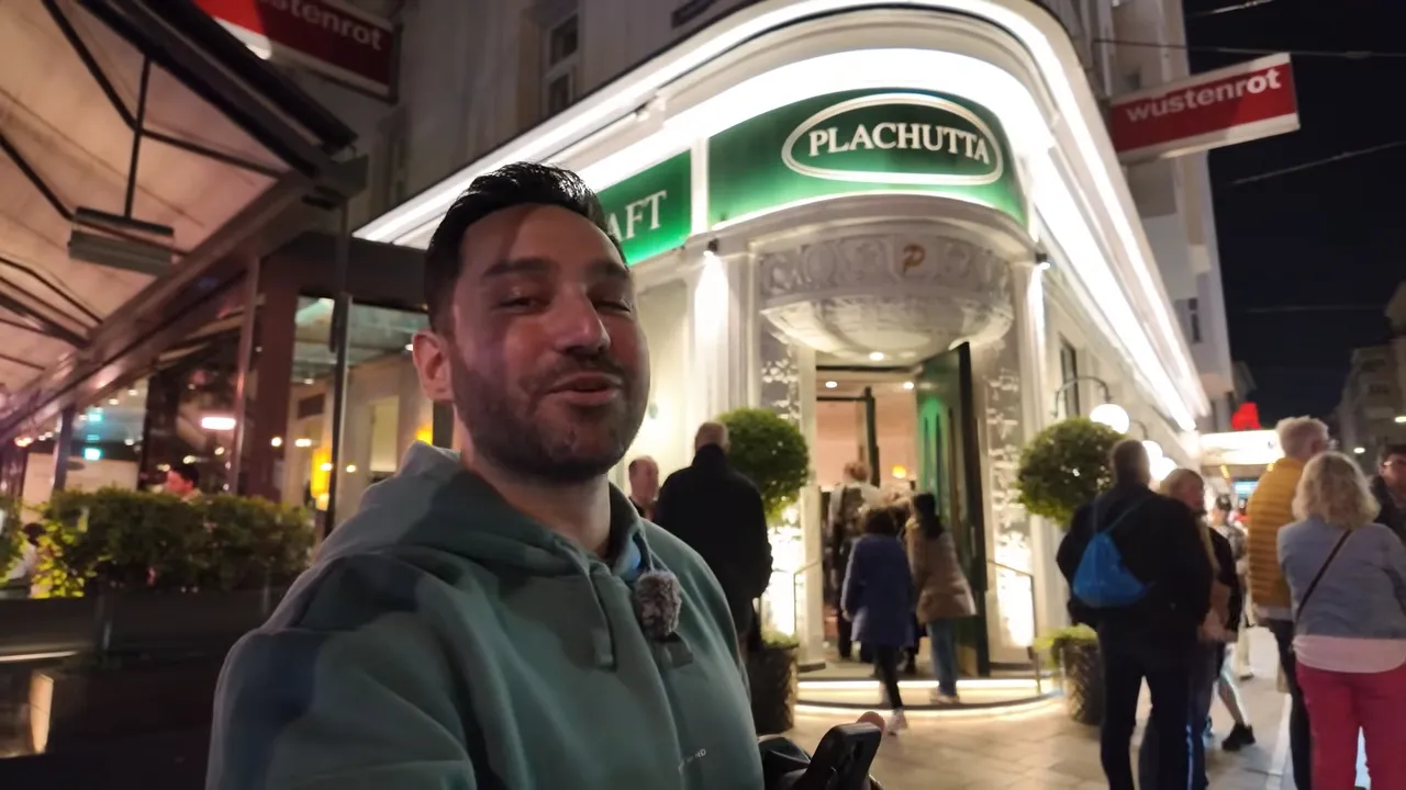 Plachutta Wollzeile restaurant lit up at night with its green sign