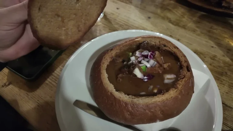 Beef goulash served in a round bread bowl at Mlejnice restaurant, Prague