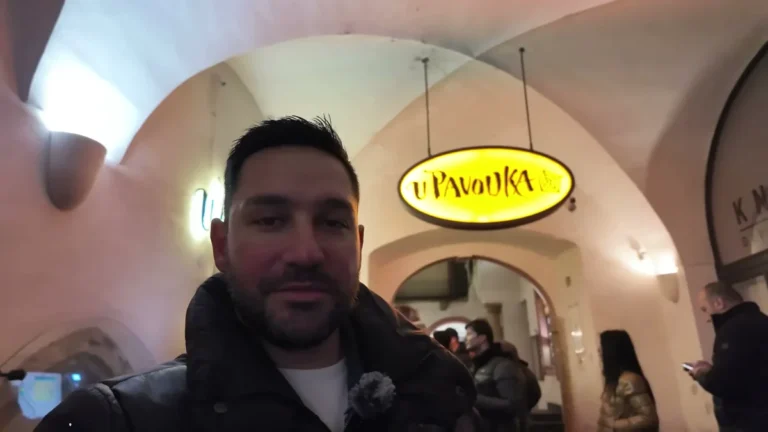 Halil Şımır at the entrance and sign of U Pavouka medieval tavern in Prague